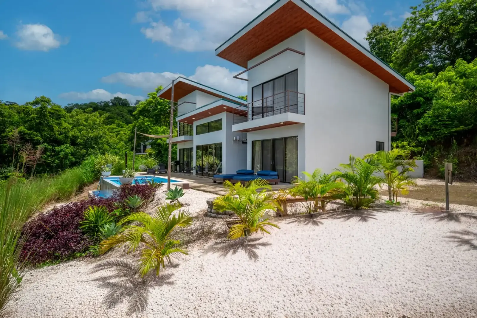 White contemporary villa with landscaped garden at Casa Coroico, Pinilla Highlands